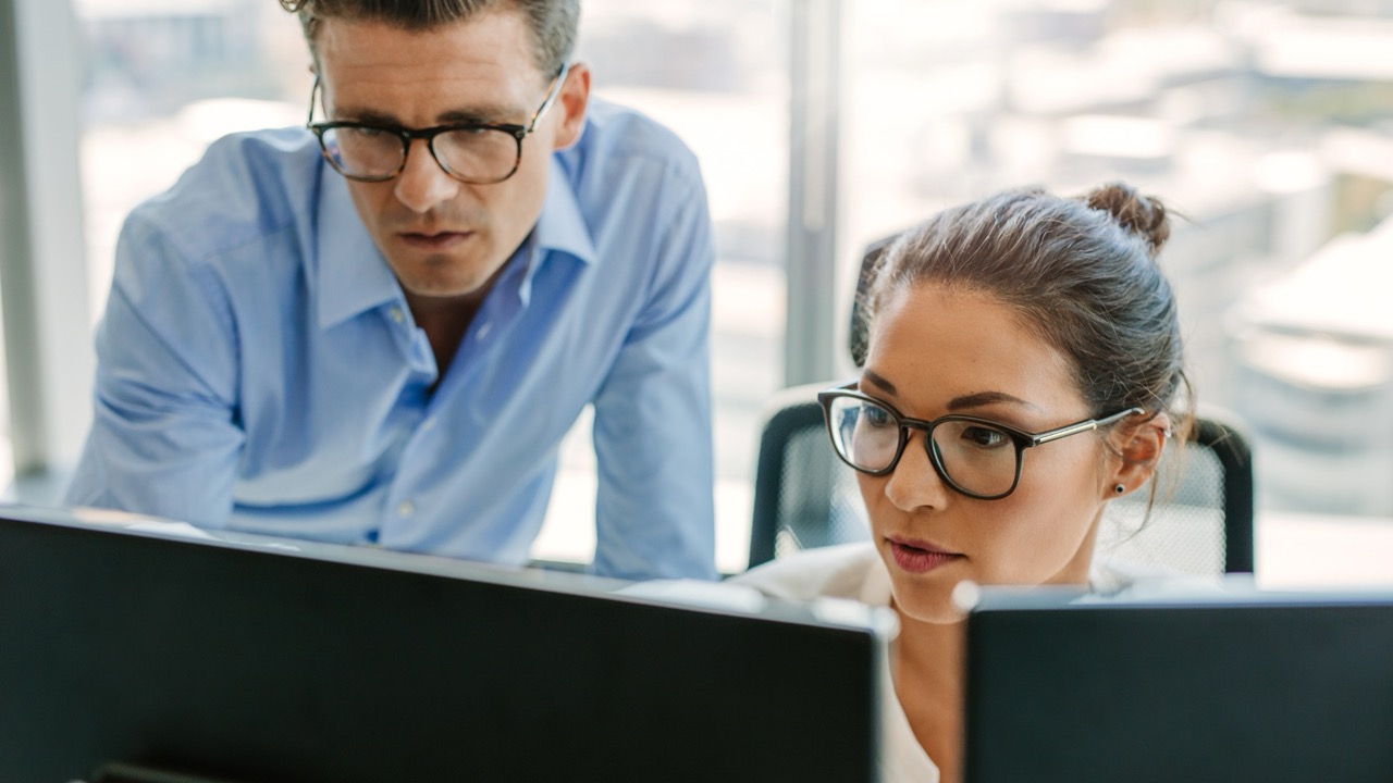 Professionals analyzing cyber threats on monitors